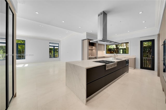 kitchen with island range hood, a sink, ornamental molding, modern cabinets, and a large island with sink