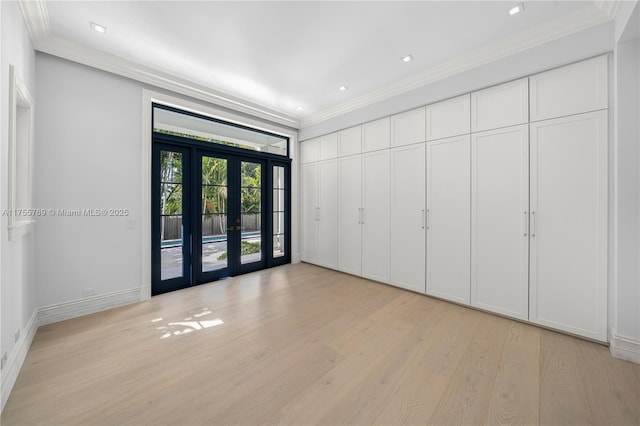 empty room with recessed lighting, baseboards, light wood-style floors, french doors, and crown molding