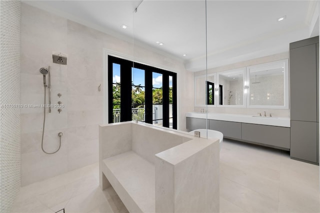 full bathroom featuring visible vents, a tile shower, vanity, and crown molding