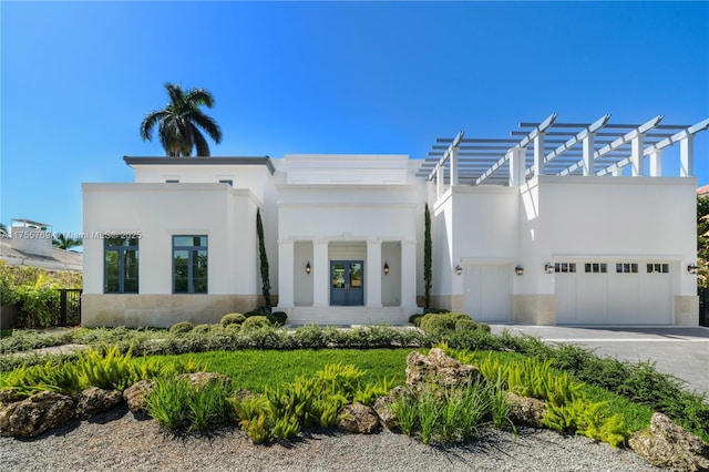 view of front of property featuring decorative driveway, a pergola, an attached garage, and stucco siding