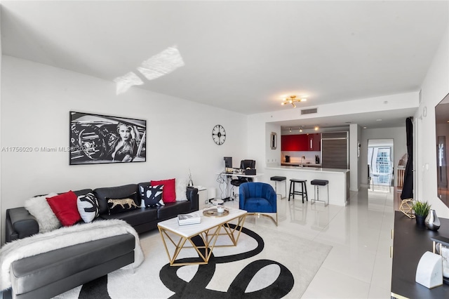 living room with light tile patterned floors and visible vents