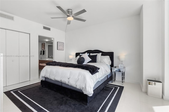 bedroom featuring a ceiling fan, tile patterned flooring, visible vents, and ensuite bath