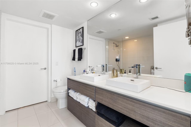 full bath with visible vents, a sink, and a shower stall