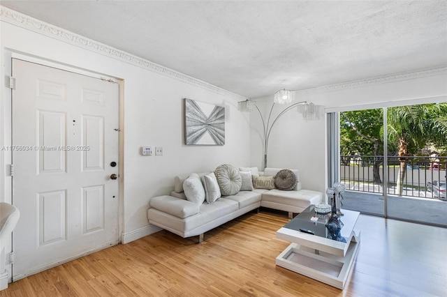 living area with light wood-style floors and a textured ceiling