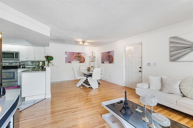 living room with light wood-style flooring and baseboards