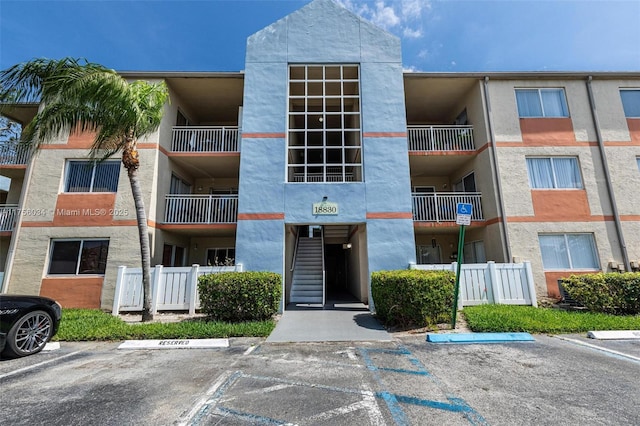 view of building exterior featuring uncovered parking