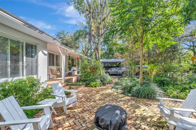 view of patio / terrace with a ceiling fan and a grill