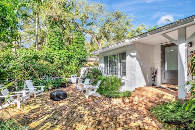 exterior space with a patio area and stucco siding