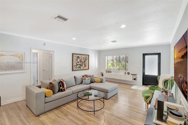 living room featuring baseboards, visible vents, crown molding, light wood-style floors, and recessed lighting