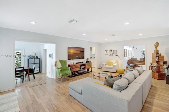 living room featuring recessed lighting, visible vents, and light wood-style floors