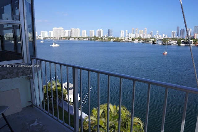 balcony featuring a view of city and a water view