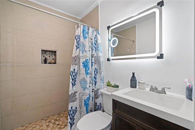 bathroom with tiled shower, vanity, and toilet