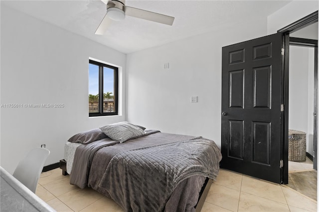 bedroom with a ceiling fan and light tile patterned flooring