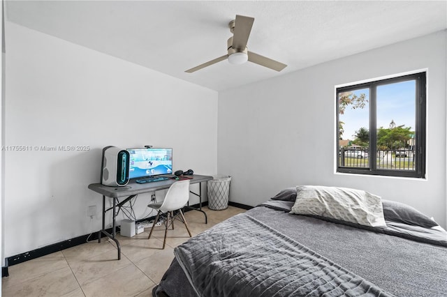 tiled bedroom featuring ceiling fan and baseboards