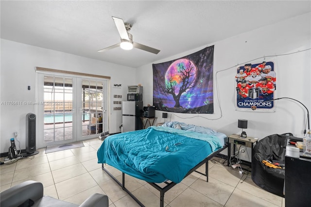 tiled bedroom with ceiling fan, french doors, freestanding refrigerator, and access to exterior