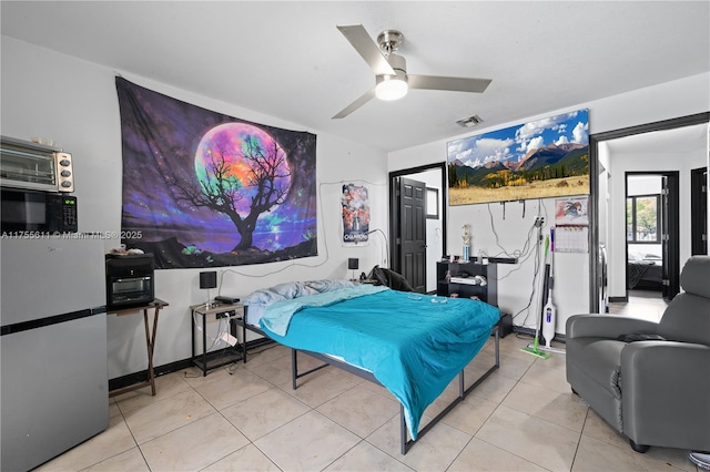 bedroom featuring a ceiling fan, visible vents, and tile patterned floors