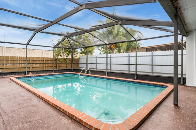 view of pool featuring a fenced in pool, glass enclosure, and a fenced backyard