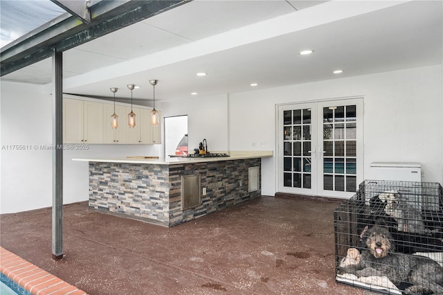 interior space with recessed lighting, french doors, and decorative light fixtures