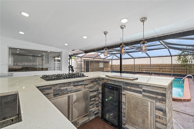 view of patio / terrace featuring exterior kitchen, wine cooler, a lanai, and fence