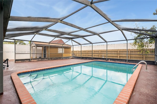 view of pool featuring a patio area, fence, a fenced in pool, and a lanai