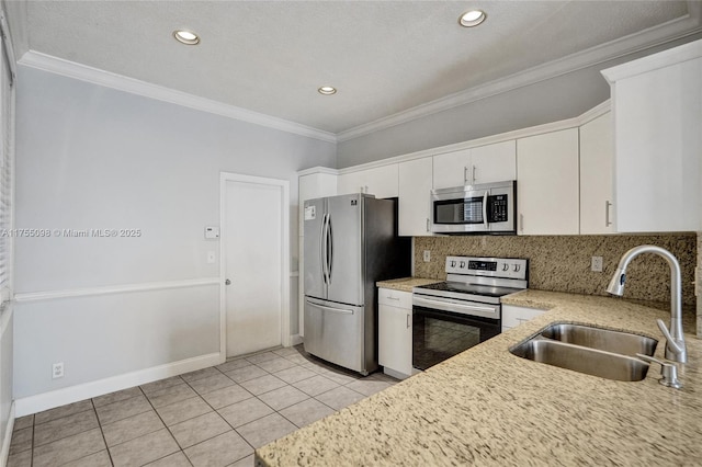 kitchen featuring crown molding, tasteful backsplash, appliances with stainless steel finishes, white cabinets, and a sink