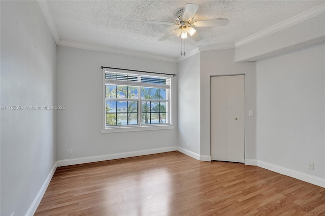 unfurnished bedroom with a textured ceiling, ornamental molding, and light wood-type flooring