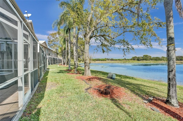 view of yard featuring glass enclosure and a water view