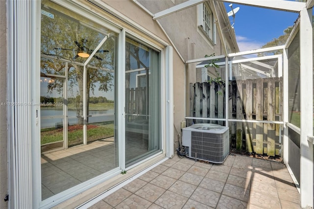 balcony featuring a water view and cooling unit