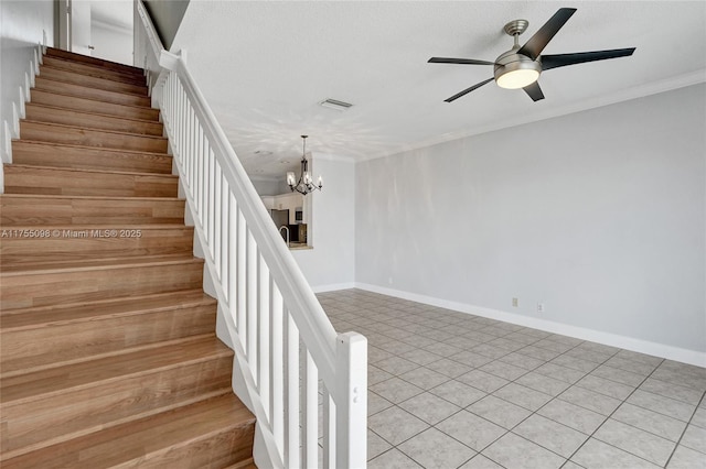 stairway featuring visible vents, ornamental molding, baseboards, and ceiling fan with notable chandelier