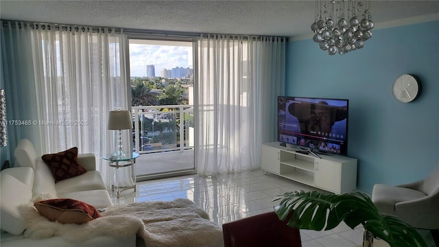 living area featuring floor to ceiling windows, a textured ceiling, an inviting chandelier, and light tile patterned floors