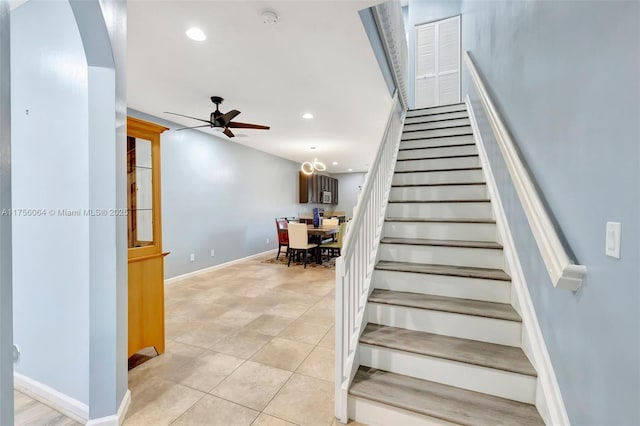 stairs featuring ceiling fan, baseboards, tile patterned flooring, and recessed lighting