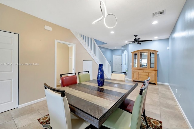 dining room with visible vents, arched walkways, stairs, light tile patterned flooring, and recessed lighting