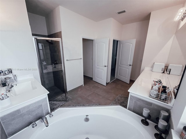 full bath featuring a stall shower, visible vents, a garden tub, and vanity