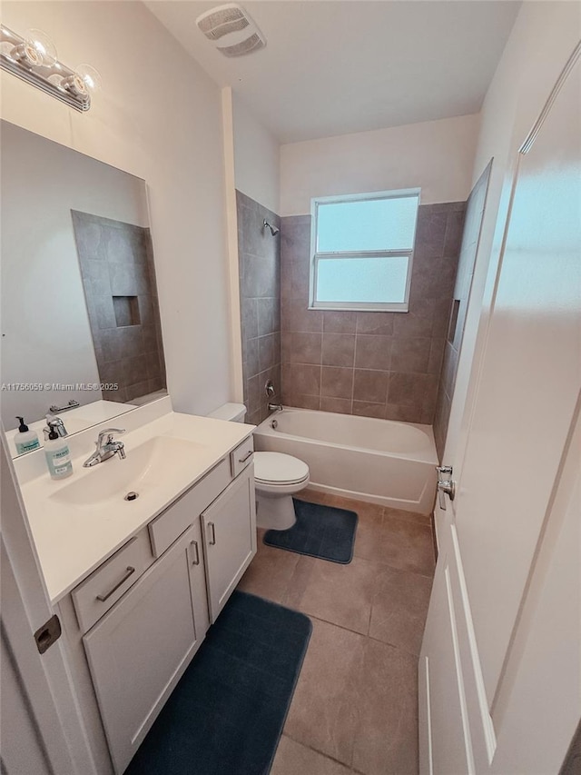 full bath with shower / bathtub combination, visible vents, toilet, vanity, and tile patterned floors