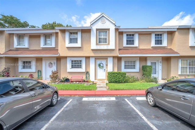 multi unit property with uncovered parking and stucco siding