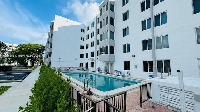 pool featuring a patio and fence