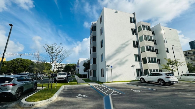 view of building exterior with uncovered parking