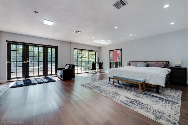 bedroom featuring french doors, wood finished floors, and visible vents