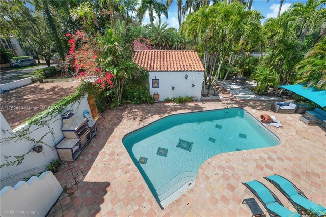 outdoor pool with a patio area