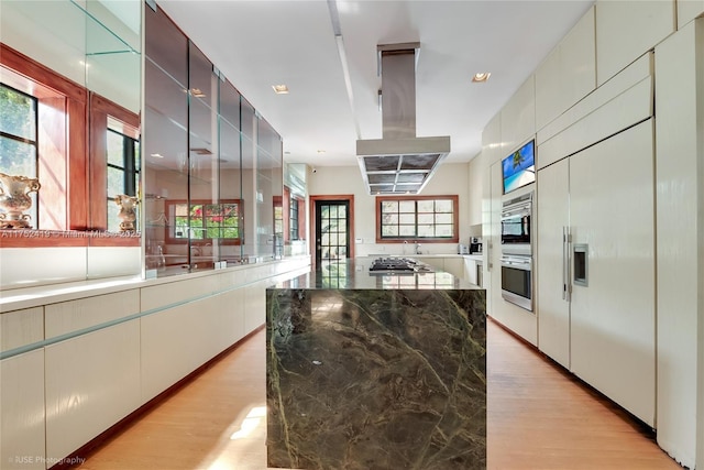 1624 Granada Blvd, Coral Gables, FL 33134 - kitchen featuring light wood-type flooring, appliances with stainless steel finishes, island exhaust hood, and healthy amount of natural light
