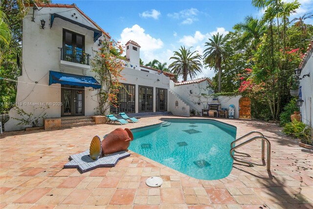 view of pool with a fenced in pool, french doors, and a patio