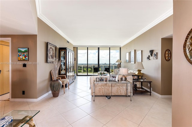 living area with baseboards, ornamental molding, and light tile patterned flooring