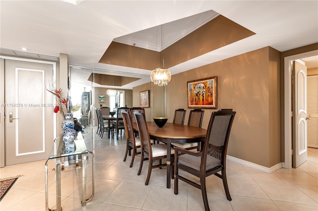 dining room with baseboards, a raised ceiling, a notable chandelier, and light tile patterned flooring