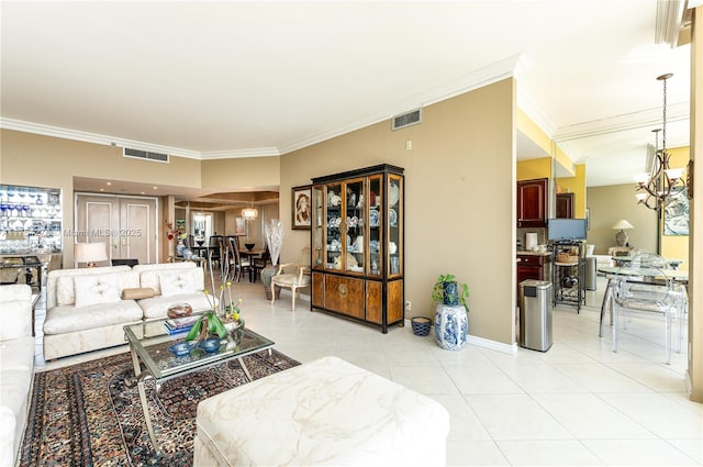 living room with light tile patterned floors, visible vents, a chandelier, and crown molding