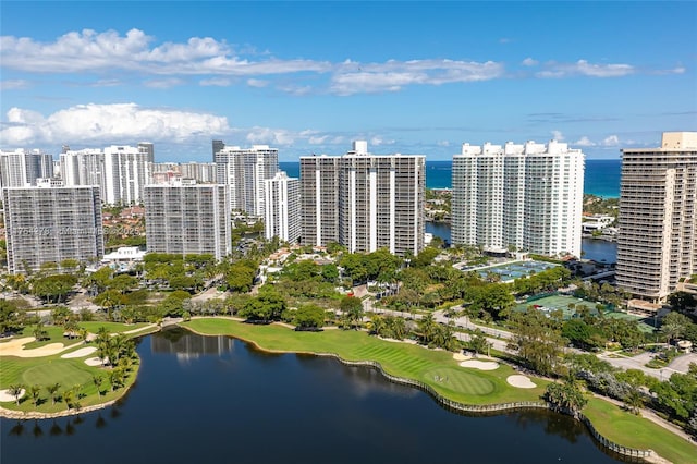 aerial view with a water view, view of golf course, and a view of city