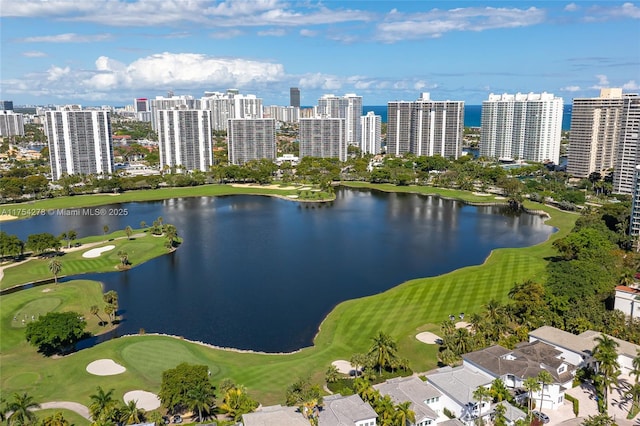 aerial view with a water view, a view of city, and golf course view