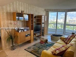 living room with light tile patterned floors and wallpapered walls