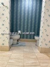 bathroom featuring toilet and tile patterned floors