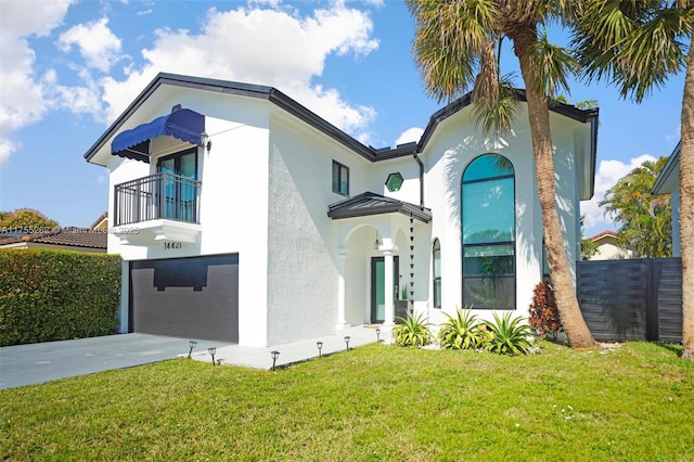 view of front of property featuring an attached garage, driveway, a front lawn, and stucco siding