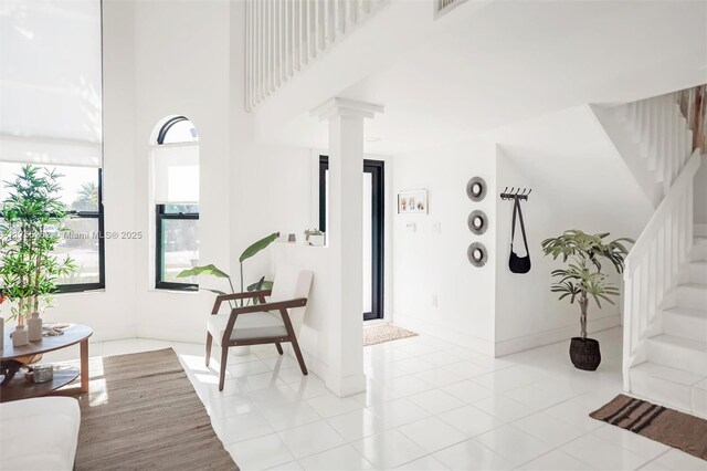 14421 SW 116th Ter, Miami, FL 33186 - entryway with stairs, ornate columns, a high ceiling, and light tile patterned floors